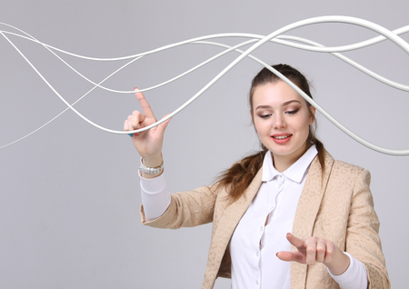 Young woman with electrical cables or wires, curved linesの写真素材