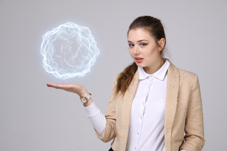 Woman with glowing magical energy ball on gray background.の写真素材