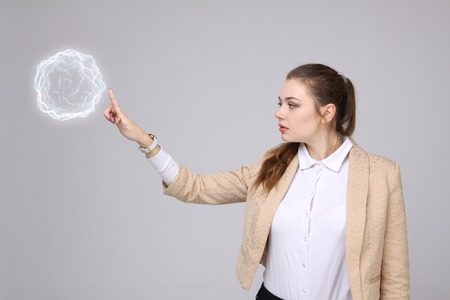 Woman with glowing magical energy ball on gray background.の写真素材