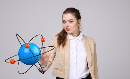 Woman scientist with atom model on grey background, research conceptの写真素材