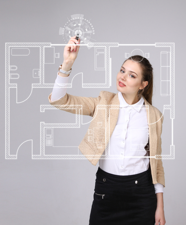 Young woman architect working with a virtual apartment planの写真素材