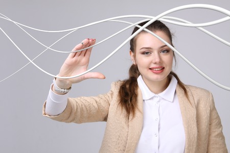 Young woman with electrical cables or wires, curved linesの写真素材