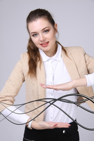Young woman with electrical cables or wires, curved linesの写真素材