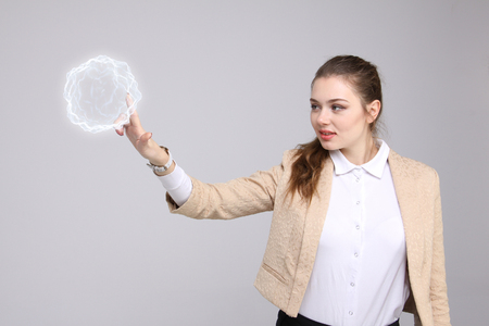 Woman with glowing magical energy ball on gray background.の写真素材