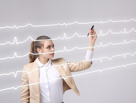 young doctor woman and cardiogram lines in airの写真素材