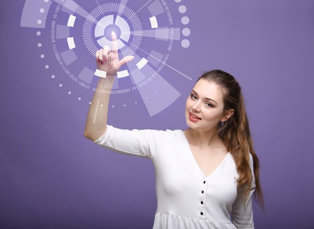 Future technology. Touch button interface. Woman working with futuristic interfaceの写真素材