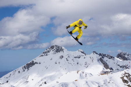 Snowboarder jumping on mountains. Extreme winter sport.の写真素材