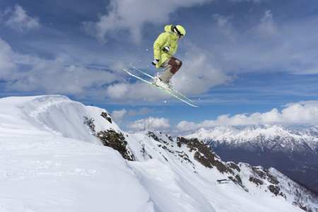 Flying skier on mountains. Extreme winter sport.の写真素材