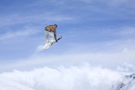 Ski rider jumping on mountains. Extreme ski freeride sport.の写真素材
