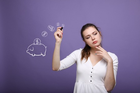 young businesswoman, woman drawing a piggy Bankの写真素材