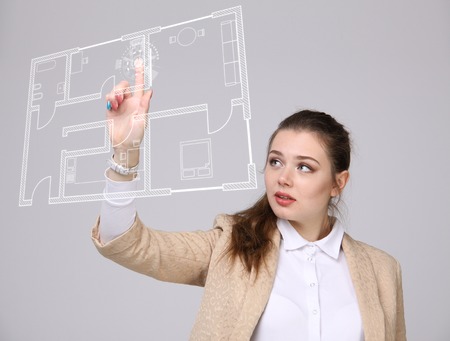 Female architect working with a virtual apartment plan. Virtual house design software.の写真素材