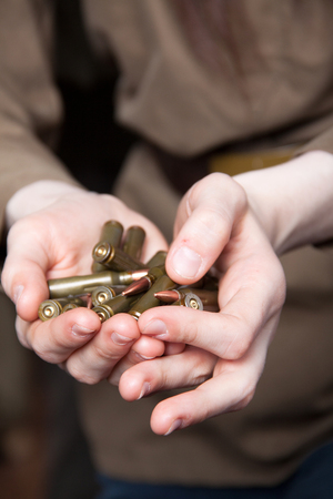 Bullets in the female hands. Live ammunition.の写真素材