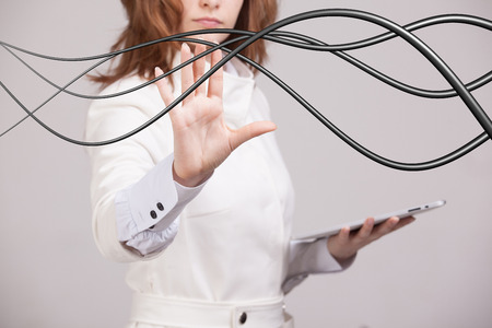 Young woman with electrical cables or wires, curved linesの写真素材