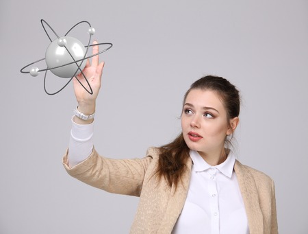 Woman scientist with structure atom model on grey background, research conceptの写真素材