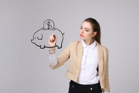 young businesswoman, woman drawing a piggy Bankの写真素材