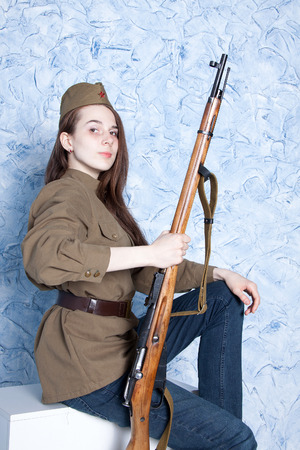 Young woman in Russian military uniform with rifle. Female soldier during the second world war.の写真素材