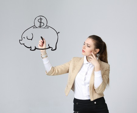 young businesswoman, woman drawing a piggy Bankの写真素材