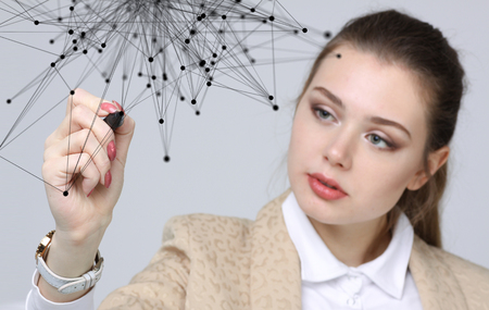 Worldwide network or wireless internet connection futuristic concept. Young woman working with linked dots on grey background.の写真素材