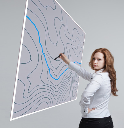 Geographic information systems concept, woman scientist working with futuristic interface in GIS software on a transparent screen.の写真素材