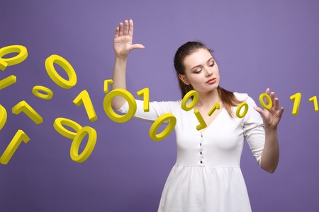 Young woman working with binary code, concept of digital technology.の写真素材