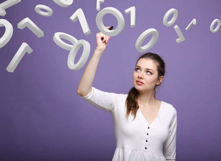 Young woman working with binary code, concept of digital technology.の写真素材