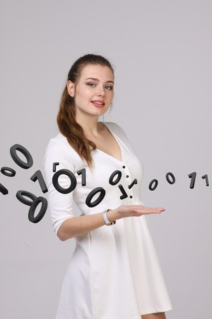 Young woman working with binary code, concept of digital technology.の写真素材