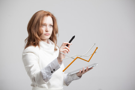Young businesswoman working with growth graph. Financial business concept on grey backgroundの写真素材
