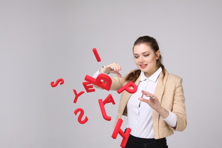 Young woman working with a set of letters, writing concept.