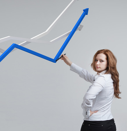 Young businesswoman working with growth graph. Financial business concept on grey backgroundの写真素材