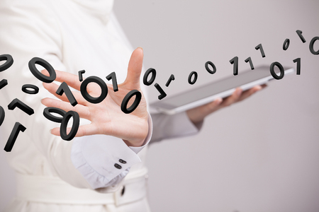 Young woman working with binary code, concept of digital technology.の写真素材