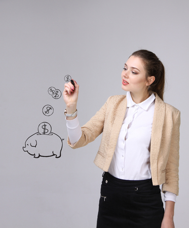 young businesswoman, woman drawing a piggy Bankの写真素材