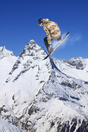 Snowboarder jumps on winter mountain. Extreme sport.の写真素材