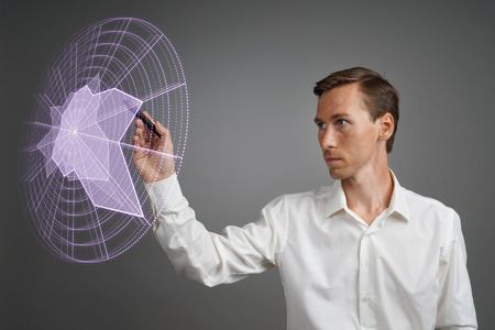 Young man working with interactive Sci-Fi HUD interface. High-tech concept.の写真素材