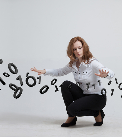 Young woman working with binary code, concept of digital technology.の写真素材