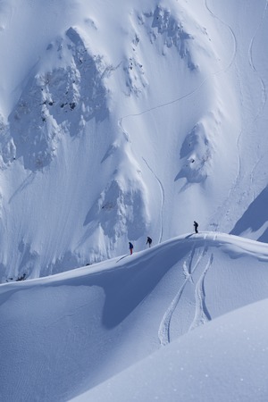 Snowboard freeride, snowboarders and tracks on a mountain slope. Extreme winter sport.の写真素材