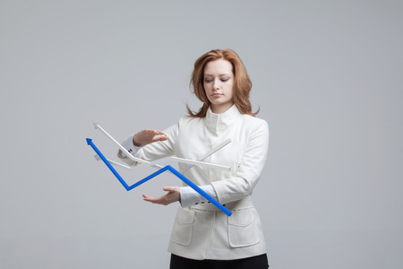 Young businesswoman working with growth graph. Financial business concept on grey background