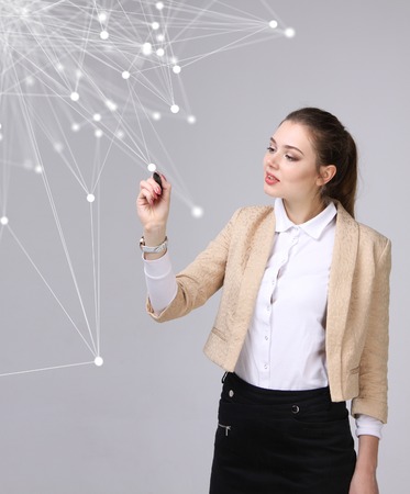 Worldwide network or wireless internet connection futuristic concept. Young woman working with linked dots on grey background.の写真素材
