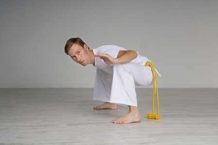 Young Man practicing capoeira (brazilian martial art with elements of dance, acrobatics and music).の写真素材