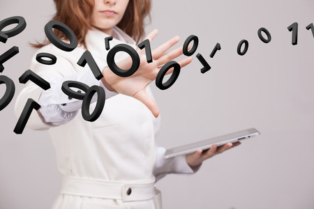 Young woman working with binary code, concept of digital technology.の写真素材