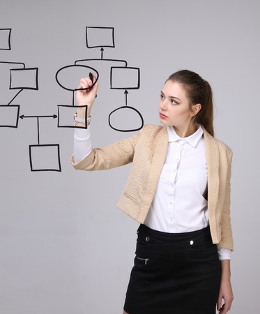 Businesswoman drawing flowchart, business process concept on grey background.の写真素材