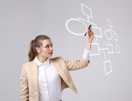 Businesswoman drawing flowchart, business process concept on grey background.の写真素材