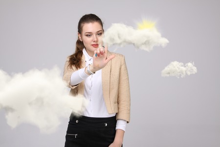 Woman with cloud and sun. Concept on the topic of computer cloud services.の写真素材