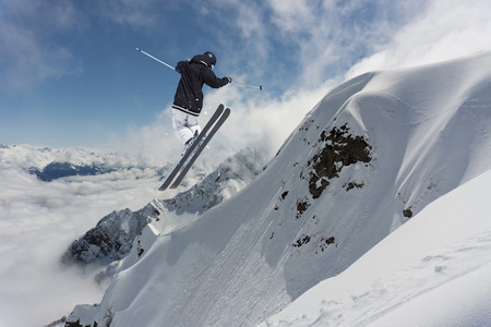 Ski rider jumping on mountains. Extreme freeride sport.の写真素材