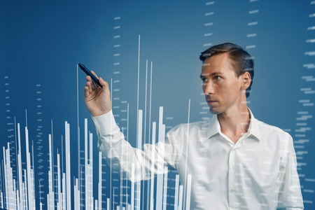 Finance data concept. Man working with Analytics. Chart graph information on digital screen.の写真素材