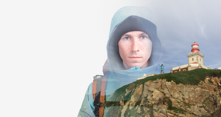 Face of young man hiker and lighthouse on a rocky cliff. Double exposure effect photography.の写真素材