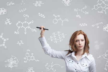 Woman chemist working with chemical formulas on grey background.の写真素材