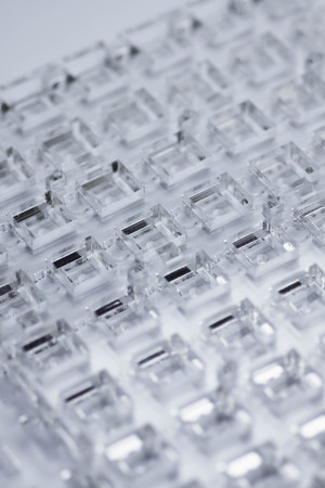 Abstract high-tech background. A sheet of transparent plastic or glass with the cut out holes. Laser cutting of plexiglass.の写真素材