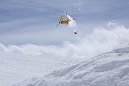 Skier jump in the mountains. Extreme ski sport. Freeride.