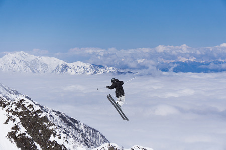 Skier jump in the snowy mountains. Extreme ski sport. Freeride.の写真素材