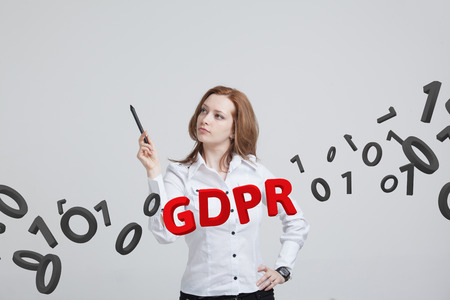 GDPR, concept image. General Data Protection Regulation, the protection of personal data. Young woman working with information.の写真素材